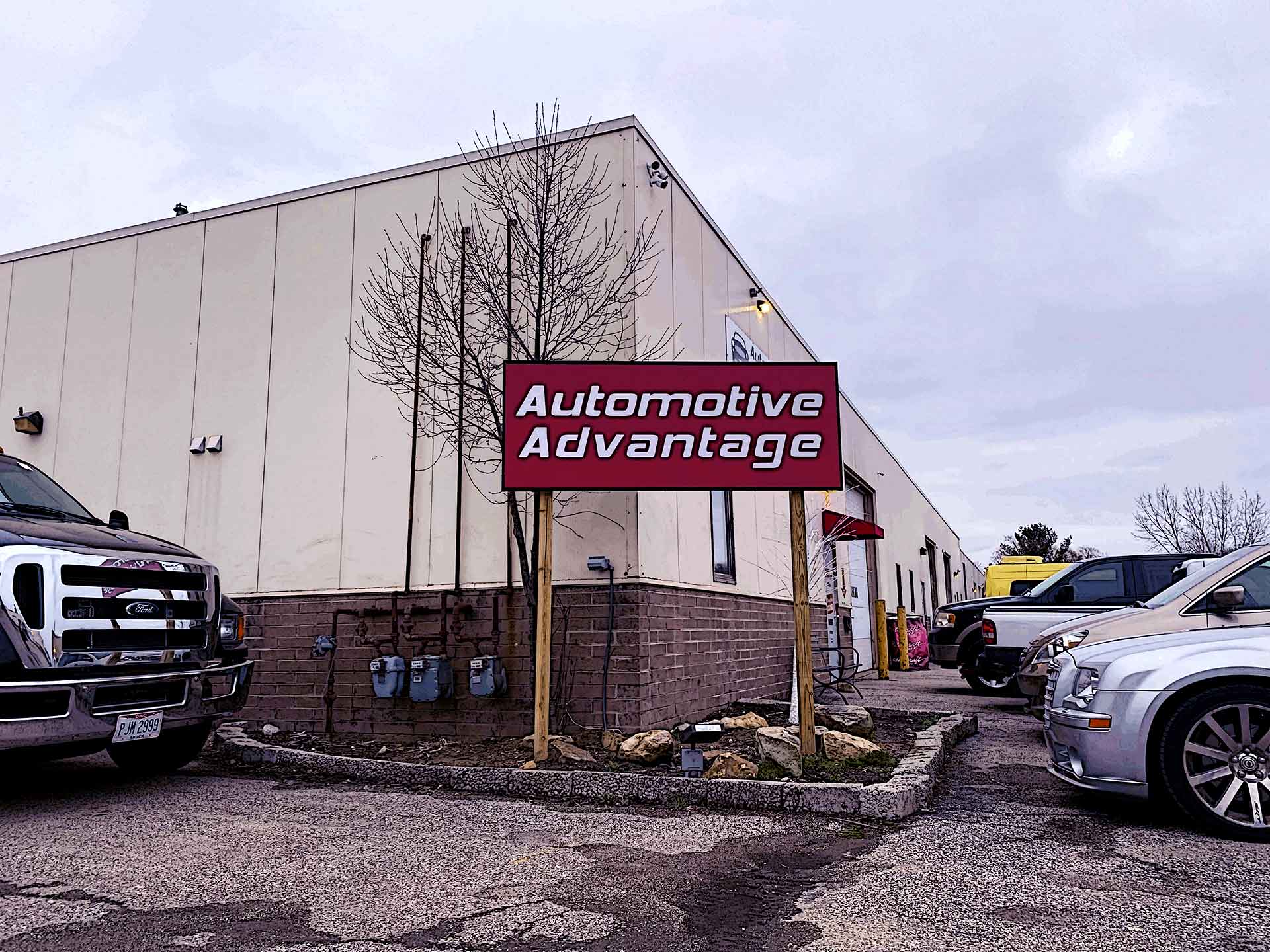 Automotive Advantage shop exterior with fleet vehicles